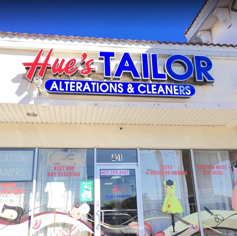 Hue's Tailor storefront on W Colonial Dr - the window reads suits & wedding gowns, custom made clothing, next day dry cleaning